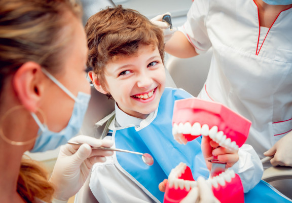 Kid with Model Teeth Ortho